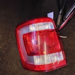 A red and white light on the side of a car.