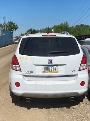 A white car parked on the side of a road.