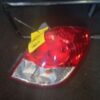 A red and silver car tail light on the road