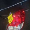A car 's tail light with the tag indicating it is not working.