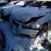 A car that has been smashed in the snow.