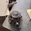 A motor is sitting on the table next to a piece of paper.